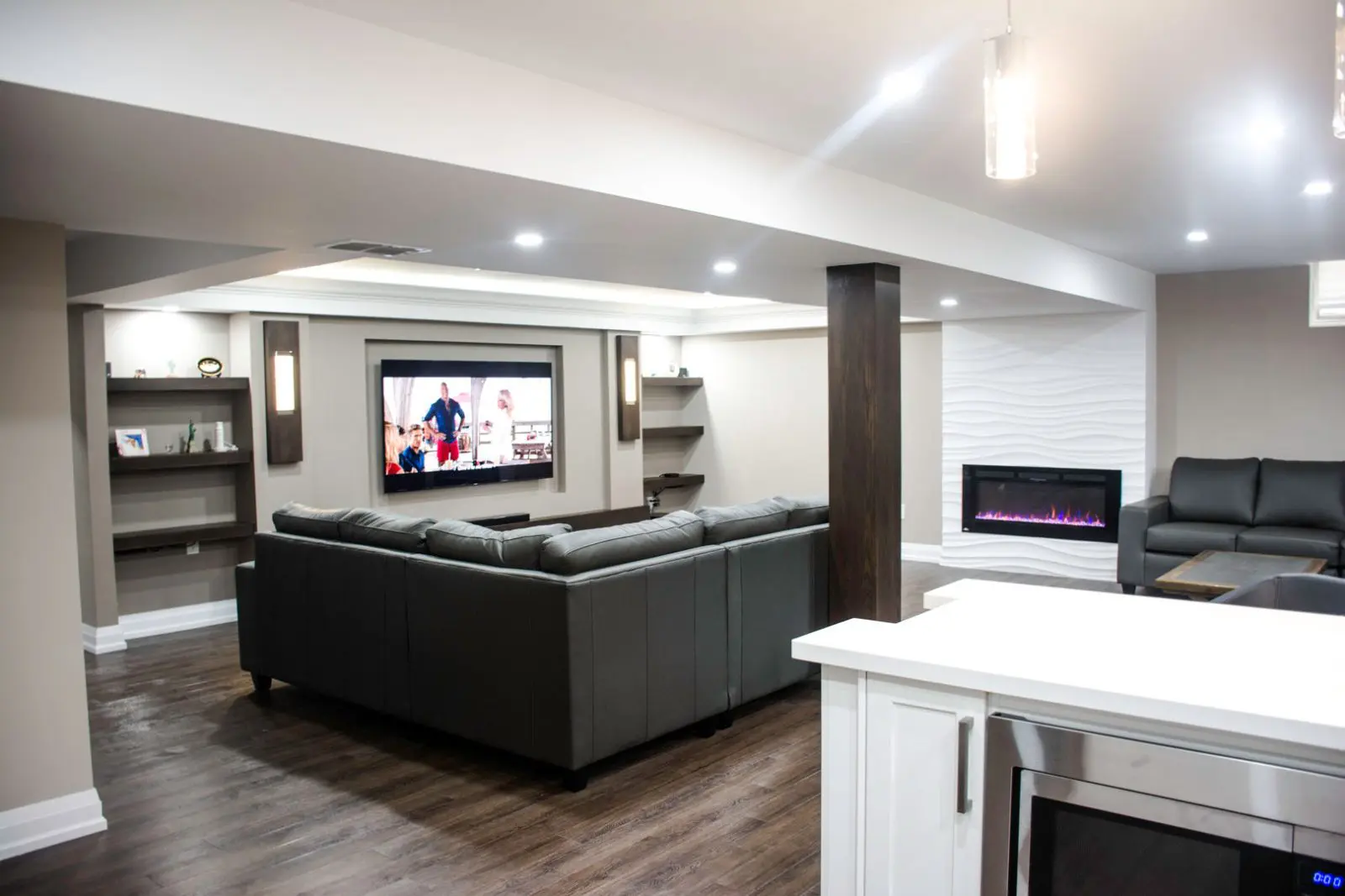custom-basement-with-mini-fridge-wooden-floor-and-ceiling-pot-lights-harmony-basements-contractors-Toronto.jpg
